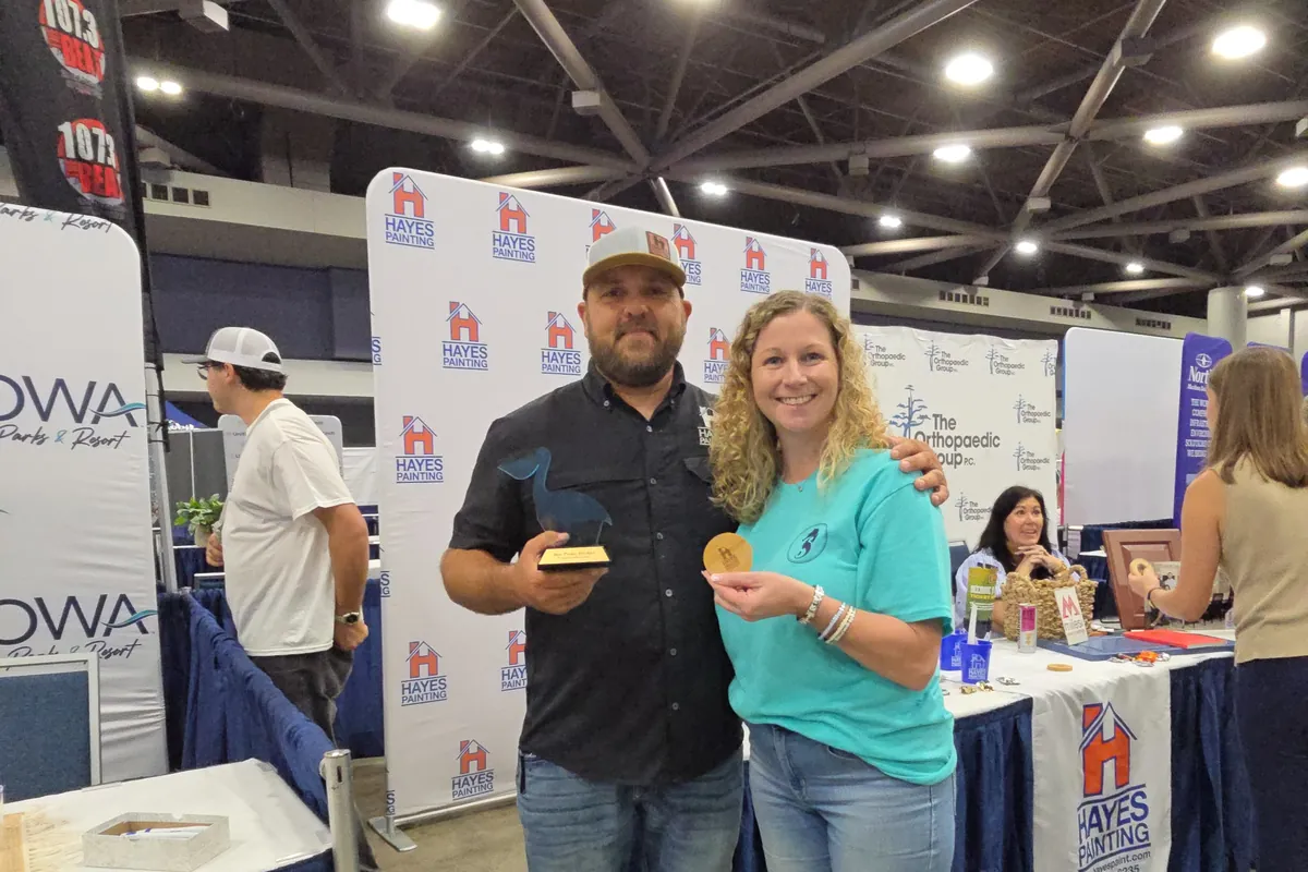 Southern View Media team members hold an award at a business expo booth