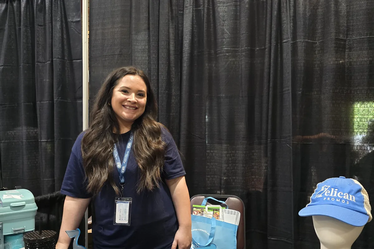Southern View Media team member at a promotional products table at an expo