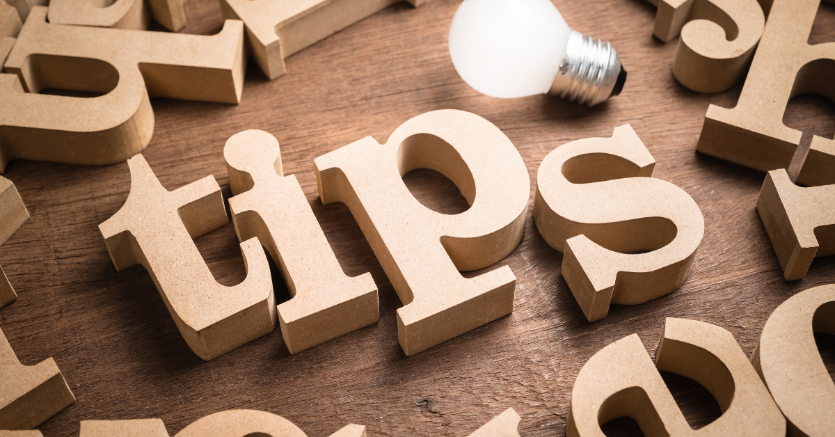 Wooden letters spelling tips with a glowing lightbulb